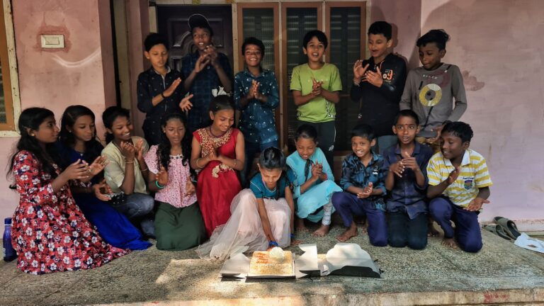 Children celebrating new year by cake cutting